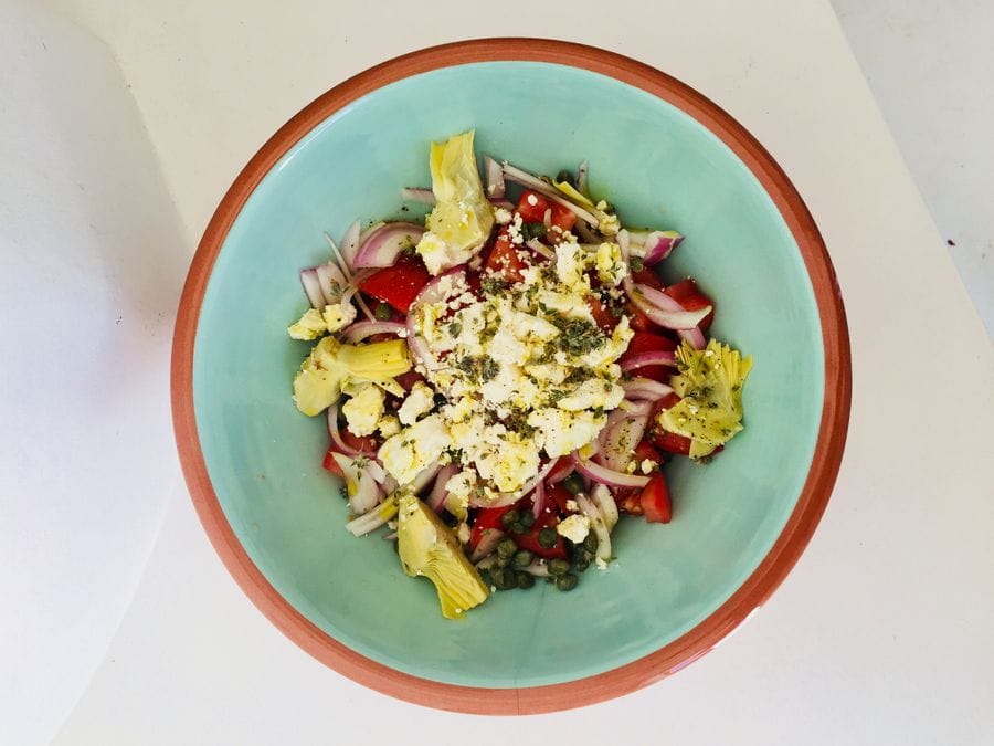 view from above of plate with traditional Greek salad and feta on the top from Greek Cooking Class from Two Minutes Angie